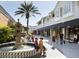 Upscale shopping center with boutique storefronts, lush landscaping, outdoor seating, and a decorative fountain at 2007 W De Leon St # C, Tampa, FL 33606