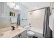 Well-lit bathroom featuring a shower-tub combination, large mirror, and modern fixtures at 215 Central Ave # 4F, St Petersburg, FL 33701