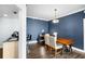 Dining room featuring a modern light fixture, hardwood floors, and desk space at 215 Central Ave # 4F, St Petersburg, FL 33701