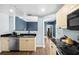 This kitchen features light-colored cabinets, black countertops, and stainless-steel appliances at 215 Central Ave # 4F, St Petersburg, FL 33701