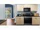 This kitchen features wooden cabinets, black countertops, and stainless-steel appliances at 215 Central Ave # 4F, St Petersburg, FL 33701