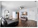 Inviting living room featuring a ceiling fan, hardwood floors, and television at 215 Central Ave # 4F, St Petersburg, FL 33701