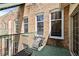 Outdoor patio with vintage brick wall and lounging chair at 215 Central Ave # 4F, St Petersburg, FL 33701