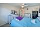 Bright bedroom with a blue comforter, ceiling fan, closet, dresser, and carpet, creating a relaxing haven at 2348 Shelley St # 13, Clearwater, FL 33765