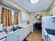 Bright kitchen features white cabinets and stainless steel double sink at 2348 Shelley St # 13, Clearwater, FL 33765