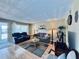 Cozy living room with hardwood floors, neutral tones, comfortable seating, and access to a screened balcony at 2348 Shelley St # 13, Clearwater, FL 33765