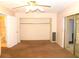 This carpeted bedroom features a large closet and an ensuite bathroom at 2449 Columbia Dr # 53, Clearwater, FL 33763