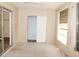 This bedroom is carpeted and features a sliding glass door leading to the outside at 2449 Columbia Dr # 53, Clearwater, FL 33763