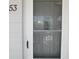 Condo front door with screen, next to house number fifty-three at 2449 Columbia Dr # 53, Clearwater, FL 33763