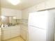 Practical kitchen offering white cabinetry, a Frigidaire fridge, and tiled walls at 2449 Columbia Dr # 53, Clearwater, FL 33763