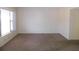 Inviting living room with plush carpeting, white walls, and a bright window at 2449 Columbia Dr # 53, Clearwater, FL 33763