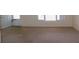 Living room with carpet, white walls, a door, and a window at 2449 Columbia Dr # 53, Clearwater, FL 33763