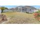 Generous backyard featuring a screened enclosure and ample space for outdoor enjoyment at 2863 Duncan Tree Cir, Valrico, FL 33594