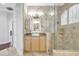 Beautiful bathroom showcasing marble accents, a frameless glass shower, and light wood cabinets at 2863 Duncan Tree Cir, Valrico, FL 33594