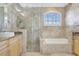 Bathroom featuring a glass shower, tub, and wooden cabinets at 2863 Duncan Tree Cir, Valrico, FL 33594