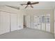 Comfortable bedroom featuring neutral carpet, and louvered windows at 2863 Duncan Tree Cir, Valrico, FL 33594
