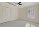 Bedroom featuring carpet floor, ceiling fan and closet with white doors at 2863 Duncan Tree Cir, Valrico, FL 33594