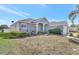 Beautiful gray home with well-maintained lawn, decorative landscaping, and inviting front entry at 2863 Duncan Tree Cir, Valrico, FL 33594