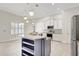 Well-lit kitchen showcasing white cabinets, stainless steel appliances, and tiled flooring at 2863 Duncan Tree Cir, Valrico, FL 33594