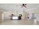 Open-concept living space with modern kitchen, tile floors, and plenty of natural light at 2863 Duncan Tree Cir, Valrico, FL 33594