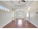Spacious living room featuring wood floors, tray ceiling, and an open floor plan at 2863 Duncan Tree Cir, Valrico, FL 33594