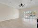 Open-concept living room with tile flooring and large windows overlooking the outdoor pool at 2863 Duncan Tree Cir, Valrico, FL 33594