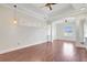 Open floor plan featuring hardwood floors, abundant natural light, tray ceilings, and modern light fixtures at 2863 Duncan Tree Cir, Valrico, FL 33594