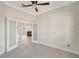 Office with glass doors leading to kitchen area; tile floor and ceiling fan at 2863 Duncan Tree Cir, Valrico, FL 33594