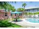 Backyard featuring a pool, patio furniture, lush lawn and a tropical landscape at 340 81St Ave, St Pete Beach, FL 33706