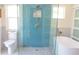 Bright bathroom featuring a glass enclosed shower, soaking tub, and white toilet at 340 81St Ave, St Pete Beach, FL 33706