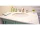 Bathroom vanity with marble countertop, chrome faucet, and green painted cabinet base with louvered doors at 340 81St Ave, St Pete Beach, FL 33706