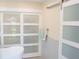 Bathroom showcasing modern sliding frosted doors, towel rack and sleek design at 340 81St Ave, St Pete Beach, FL 33706