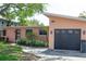 Contemporary home exterior with a modern garage door, stylish landscaping, and a well-kept lawn at 340 81St Ave, St Pete Beach, FL 33706