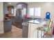 Eat-in kitchen with breakfast bar, stainless appliances, and grey cabinets at 340 81St Ave, St Pete Beach, FL 33706