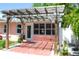 Cozy patio with a rustic pergola, string lights, and direct access to the house, offering a relaxing outdoor space at 340 81St Ave, St Pete Beach, FL 33706