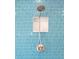 Shower with unique blue tile, a shower niche and handheld shower head at 340 81St Ave, St Pete Beach, FL 33706