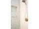 Shower with glass door, chrome fixtures, white subway tile and decorative bubble pattern tile accent wall and niche at 340 81St Ave, St Pete Beach, FL 33706