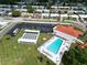Aerial view of community pool, clubhouse, parking, shuffleboard and parking area at 3800 101St N Ter # 3800, Pinellas Park, FL 33782