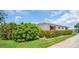 Landscaped front yard of home, featuring flowering bushes and manicured green lawn at 3800 101St N Ter # 3800, Pinellas Park, FL 33782