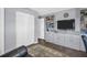 Comfortable living room area with built-in shelving and a large TV at 3800 101St N Ter # 3800, Pinellas Park, FL 33782
