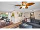 A well-lit living room adjacent to the dining area with stylish furnishings and hardwood floors at 3800 101St N Ter # 3800, Pinellas Park, FL 33782