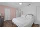 Cozy bedroom with wood floors, pink accent wall, and ample closet space at 3803 Cortez Cir # C, Tampa, FL 33614