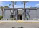 Gray two-story condo building with stairs to front door and palm trees at 3803 Cortez Cir # C, Tampa, FL 33614
