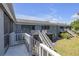 Exterior view of gray apartment complex showing access stairs to upper units and green lawn at 3803 Cortez Cir # C, Tampa, FL 33614