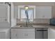 Updated kitchen featuring granite countertops, white cabinets, and stainless steel appliances at 3803 Cortez Cir # C, Tampa, FL 33614