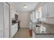 Updated kitchen featuring granite countertops, white cabinets, and stainless steel appliances at 3803 Cortez Cir # C, Tampa, FL 33614