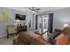 Inviting living room with modern flooring, ceiling fan and a comfortable leather sofa at 3803 Cortez Cir # C, Tampa, FL 33614