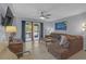 Inviting living room with modern flooring, ceiling fan and a comfortable leather sofa at 3803 Cortez Cir # C, Tampa, FL 33614