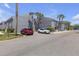 Apartment building with parking area showcasing available parking spaces, palm trees and manicured landscaping at 3803 Cortez Cir # C, Tampa, FL 33614
