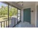 Screened-in patio offering an outdoor space with views of lush greenery and an exterior door at 3803 Cortez Cir # C, Tampa, FL 33614